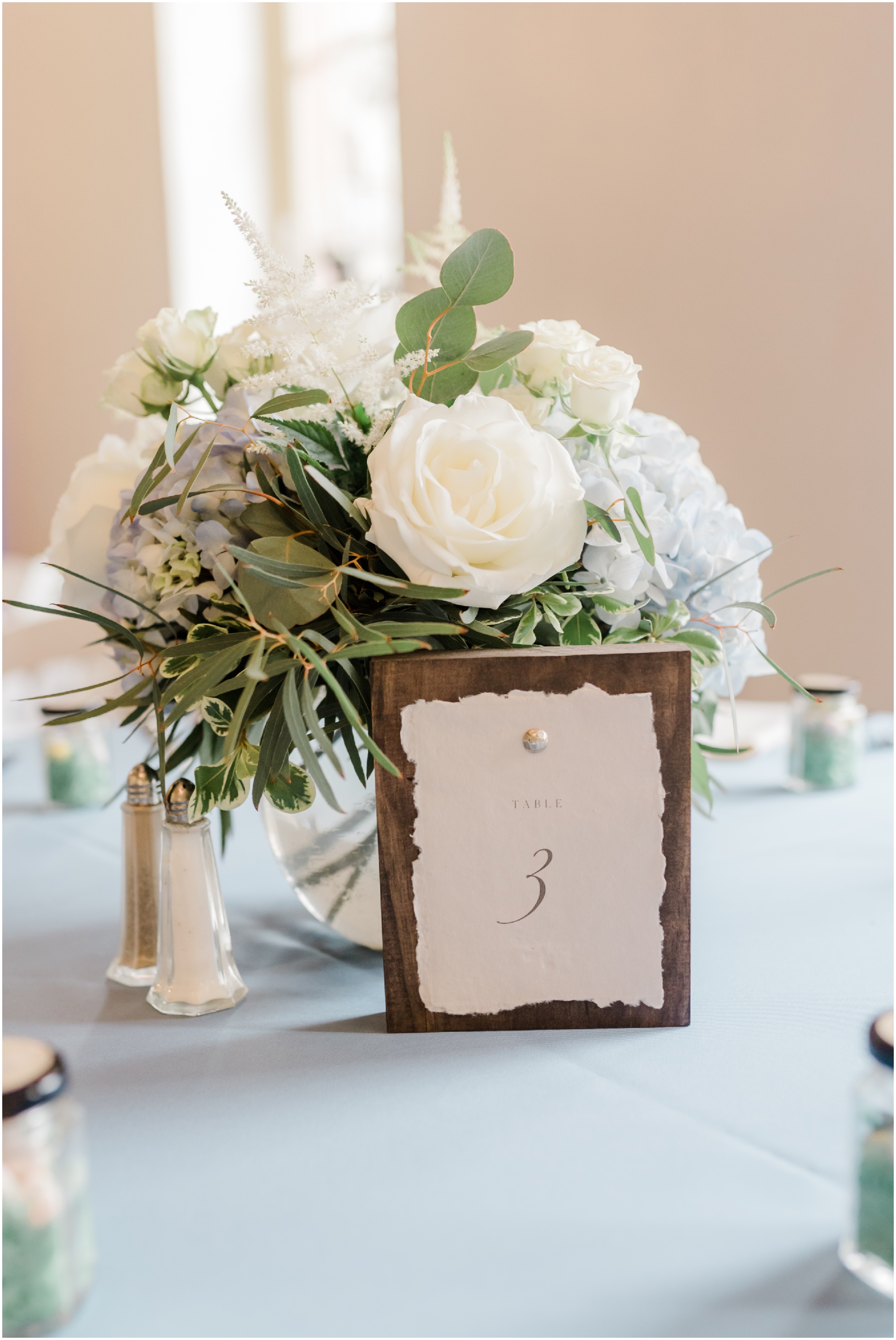 White Floral Centerpieces with Dusty Blue Tablecloths Spring Wedding by Megan Bennett Photography Simple Centerpieces