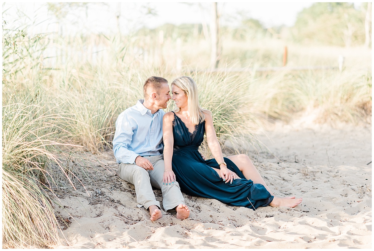 A Coastal Eastern Shore engagement photo featuring a flowy navy blue dress and a grassy beach at Terrapin Park in Stevensville, Maryland by Eastern Shore Photographer Megan Bennett Photography