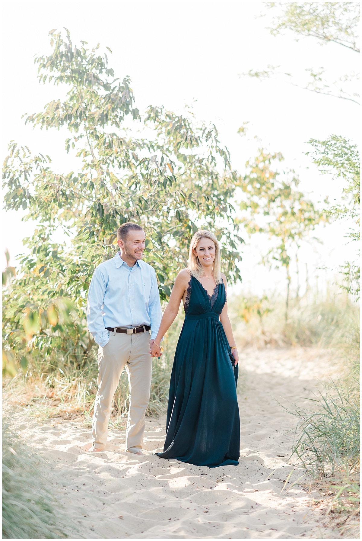 A Coastal Eastern Shore engagement photo featuring a flowy navy blue dress and a grassy beach at Terrapin Park in Stevensville, Maryland by Eastern Shore Photographer Megan Bennett Photography