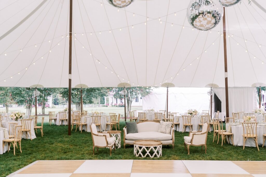 Interior view of sailcloth tent with white and wood checkered dance floor